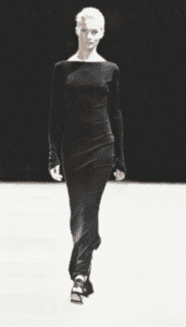 Vintage archival Azzedine Alaia Spring Summer 2003 Couture collection black asymmetric mermaid long maxi dress worn on the runway on a mannequin with a black background