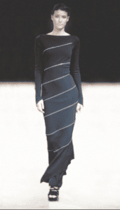Vintage archival Azzedine Alaia Spring Summer 2003 Couture collection black asymmetric mermaid long maxi dress with zipper design worn on the runway on a mannequin with a black background