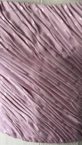 close-up of emanuel ungaro corset side zip closure on pink silk fabric