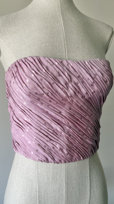 close-up of emanuel ungaro pink silk corset showing pleated texture and shiny polka dot pattern