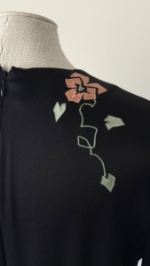 Close-up of floral embroidery on the back of Chloé black silk dress